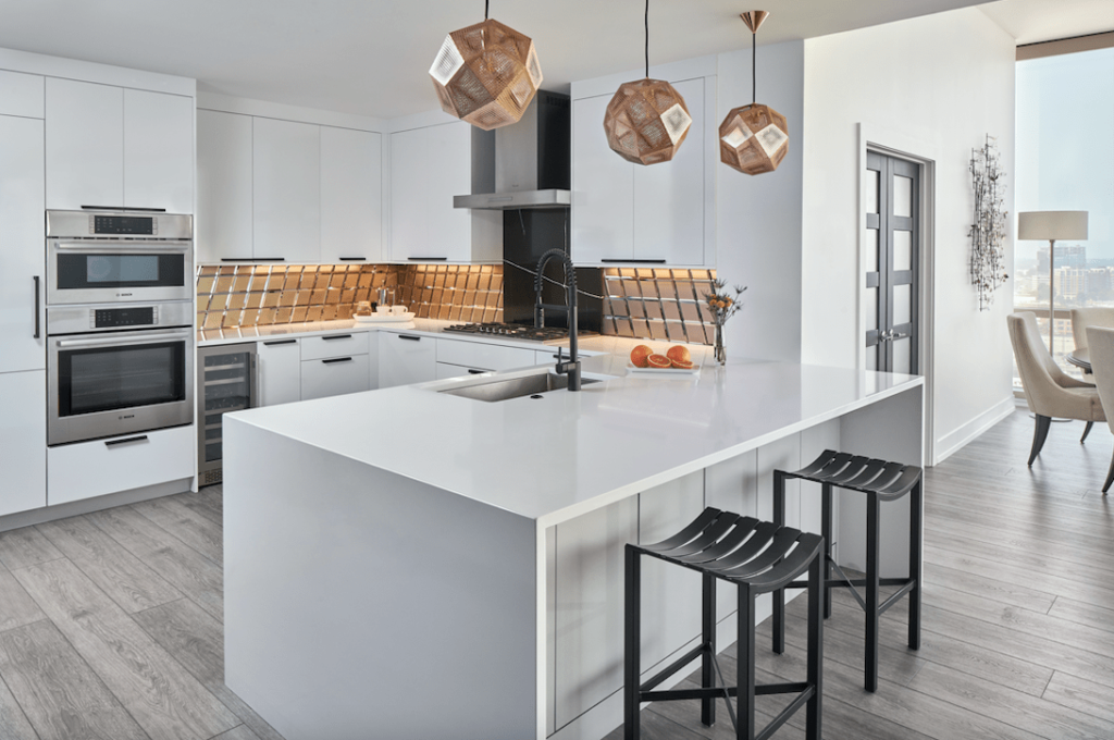 Modern kitchen featuring sleek cabinetry, quartz countertops, and stainless steel appliances, designed for both style and functionality by GMC Construction Inc.