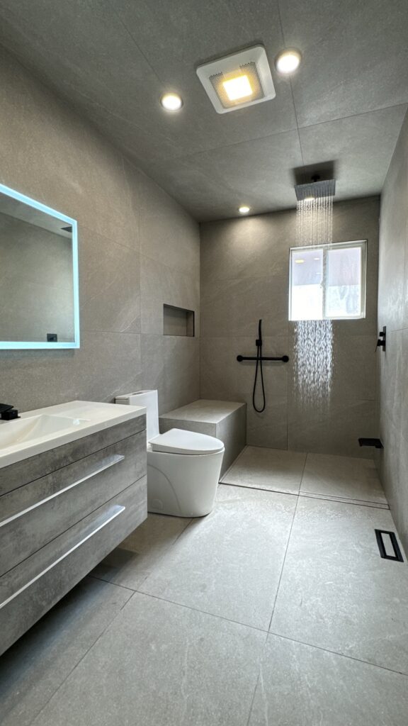 Modern bathroom renovation by GMC Construction Inc. featuring a freestanding bathtub, sleek double-sink vanity, and elegant tile work in a Toronto home.