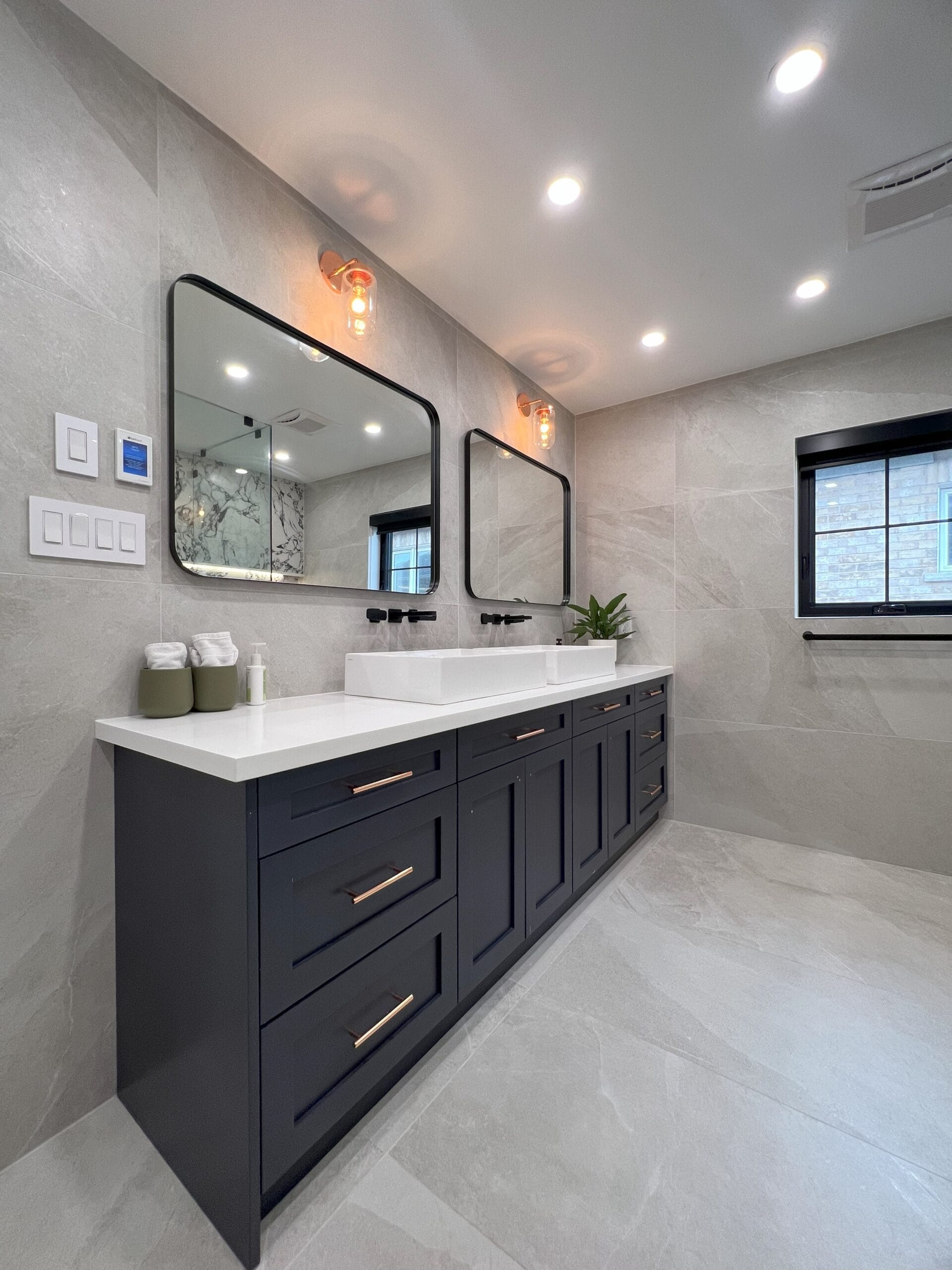 Powder room renovation by GMC Construction Inc. in Toronto, featuring updated fixtures, elegant tile work, and stylish storage solutions
