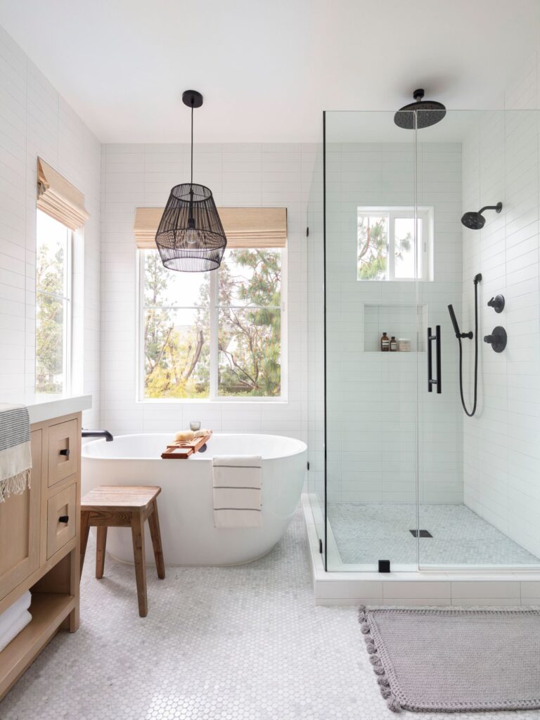 Stunning bathroom renovation by GMC Construction Inc., a leading general contractor in Toronto, showcasing a modern freestanding tub, stylish double-sink vanity, elegant tile work, and contemporary fixtures, designed for both comfort and functionality.