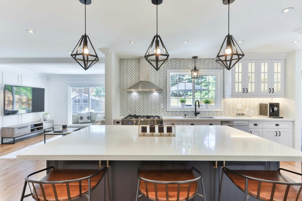 Beautiful modern kitchen with a central island and elegant seating, highlighting expert craftsmanship and design. This inviting space is perfect for kitchen renovations, combining style and functionality for family gatherings and culinary experiences. BY GMC CONSTRUCTION THE BEST GENERAL CONTRACTOR IN vaughn