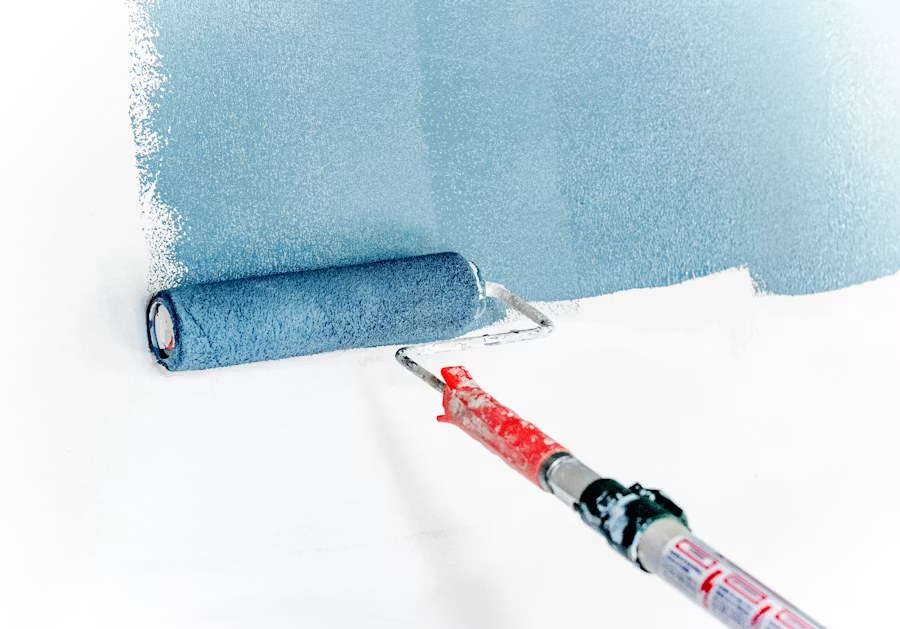 Rolling fresh paint onto an interior wall