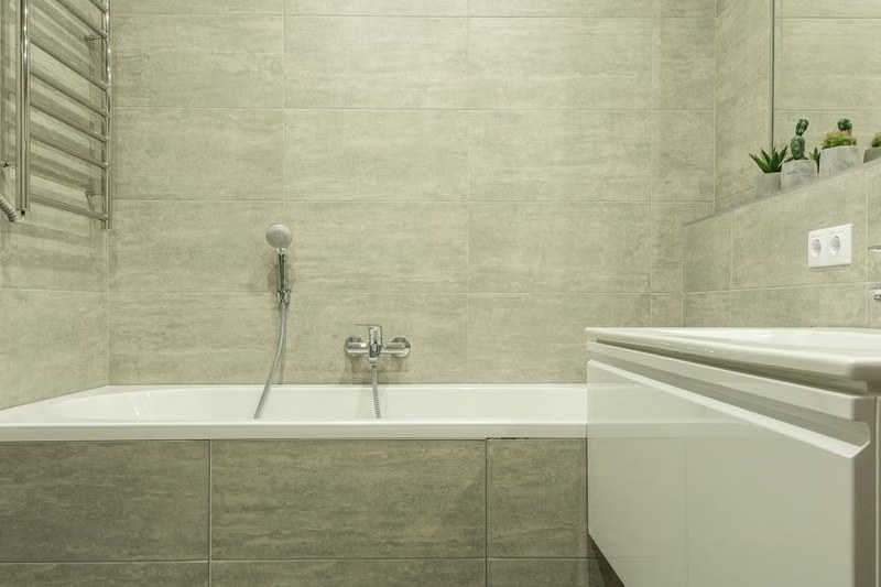 Applying fresh caulk around a bathtub